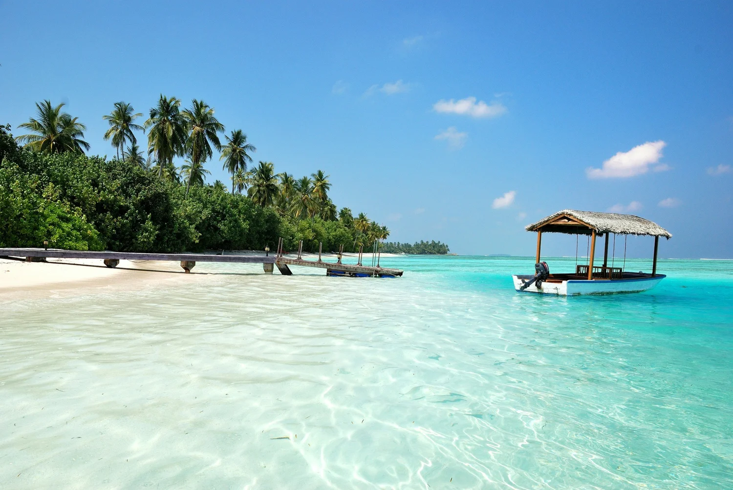 Thatched boat shelter over calm turquoise water